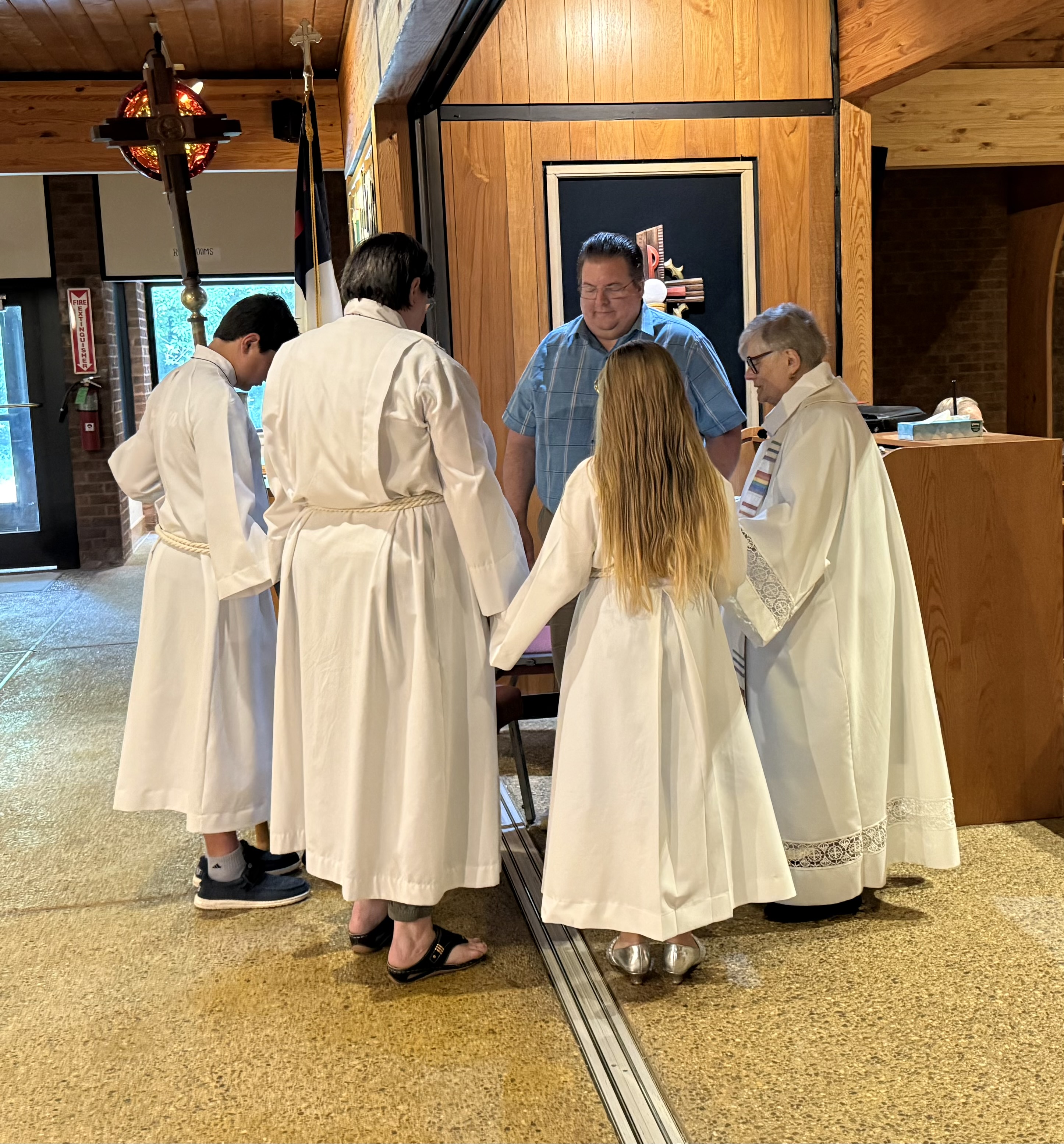 A blessing shared at the back of the sanctuary