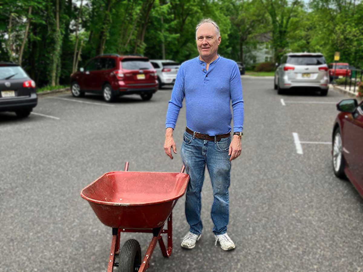 Dave Rulon with a wheelbarrow in the church parking lot
