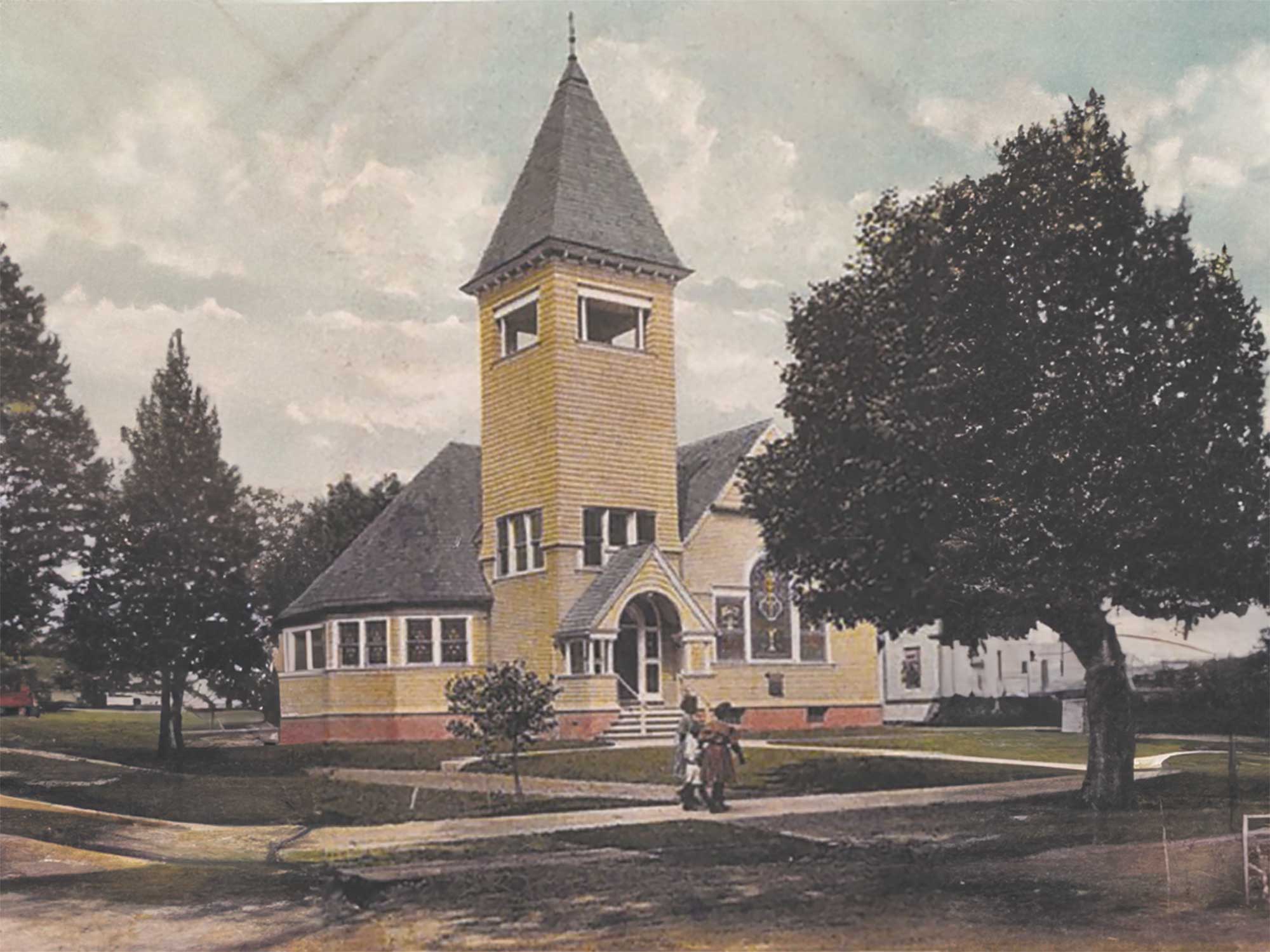 A historic black and white photograph of the original Saint Matthew Lutheran Church building, showing Gothic-style stained glass windows and a church marquee sign out front.